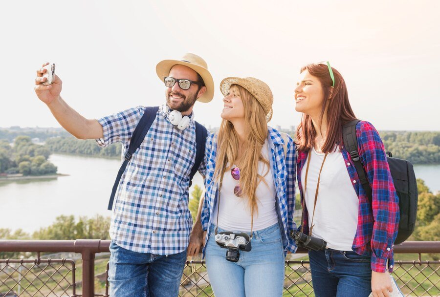 group happy friends taking selfie cellphone outdoors_23 2147950696