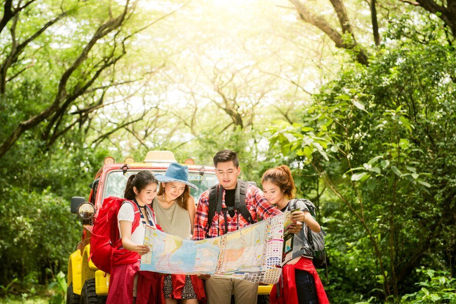 hiking hikers looking map couple friends navigating together smiling happy camping travel hike outdoors forest young mixed race asian woman man_1253 939