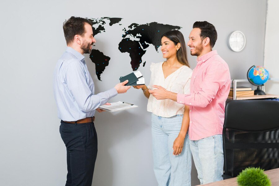 you are all set your vacations sales representative giving passports plane tickets young woman man their holiday trip travel agency_662251 2215